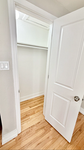 Bright and inviting closet space with hardwood flooring and ample storage potential, perfect for organization.