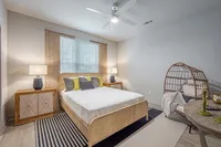 Furnished bedroom with bed and tables