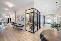 Furnished clubroom with shuffleboard table and conference room