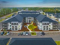 Aerial view of community with trees behind