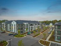 Aerial view of community with trees behind