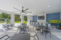 LArge covered patio with tables and chairs