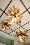 Chic ceiling with modern, leaf-inspired pendant lights in a stylish interior.
