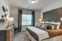 Cozy and stylish bedroom with modern decor, featuring a plush bed and large window letting in natural light.