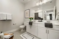Luxurious bathroom featuring dual sinks, modern decor, and elegant lighting.