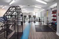 Modern fitness center with sleek gym equipment, bright natural lighting, and stylish design for an inspiring workout environment.