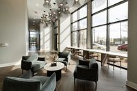 Bright, modern lobby with plush seating, elegant decor, and floor-to-ceiling windows offering abundant natural light.