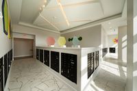 Modern mailbox area with sleek design, geometric art pieces, and unique tiled floor, offering a stylish postal solution.