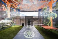 Vibrant mural-adorned space with lush greenery and an artistic ceiling design, offering a unique ambiance and a ping pong table for recreation.