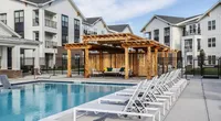 The saltwater pool is surrounded by a sundeck and luxurious cabanas.