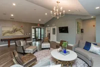 Kick back and connect in the expansive entertainment room at the Legacy Landing clubhouse—perfect for gatherings and relaxation.