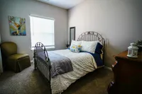 A bright, versatile secondary bedroom at The Bristol offers plenty of space to relax, work, or welcome guests — complete with large windows and modern touches.