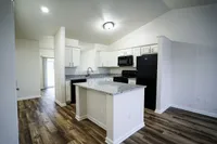 A spacious kitchen with a large island opens effortlessly into the living and dining areas at The Bristol, creating the perfect setup for gatherings and easygoing living.