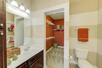 Plenty of storage meets everyday convenience — this bathroom flows right into a spacious walk-in closet to keep your routine stress-free.