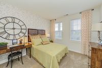Bright and roomy, this bedroom offers space to relax, recharge, and make your own — shown here with sample furniture for scale.
