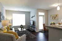 Natural light, hardwood-inspired floors, and an easy flow from room to room—this open-concept layout feels just right.