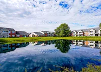 Tranquility built in. The pond at Hamilton Station reflects blue skies and calm mornings—just one more reason it feels good to come home.
