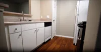 Well-maintained and functional, this classic galley-style kitchen includes a pantry and passthrough window to keep things open while you cook.