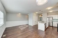 Bright, open-concept townhome living with natural light, wood-style flooring, and stainless steel appliances creates a modern and inviting space to call home.