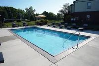 Inviting outdoor swimming pool surrounded by plush loungers, perfect for relaxation and enjoyment under the sun.