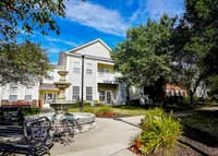 Where calm meets character: a gentle fountain flows in front of your beautifully designed apartment building.