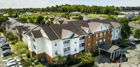 Sleek lines and lush surroundings come into focus from above. This corner view captures the calm, connected feel of the community.
