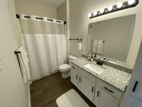 Whether it’s a quick rinse or a long soak, this bathroom delivers, complete with built-in cabinetry and a spacious vanity that keeps the clutter away.