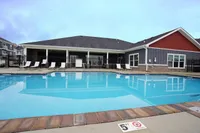 Clear water, calm vibes. The Ventry’s pool is your warm-weather go-to for a quick dip or a full day of relaxation. Inviting swimming pool area with sun loungers, perfect for relaxation and leisure in a charming modern apartment complex.