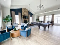 A clubhouse that doesn’t just look good — it works for everything from group chats to quiet nights in. Elegant and spacious lounge area with modern seating, large windows, and a stylish pool table for entertainment.