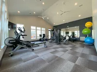 A clean, modern space with everything you need for a solid workout just steps from your front door. Modern fitness center with state-of-the-art equipment, high ceilings, and ample natural light for an energetic workout experience.