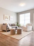 A living room designed for real life with natural light and space to spread out. Bright and inviting living room with modern sofa, cozy armchair, and stylish decor on hardwood floors.