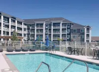 Modern apartment complex with inviting pool area and spacious balconies, ideal for relaxation and outdoor enjoyment.
