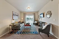 Inviting living room featuring modern decor, plush seating, and a large window with a scenic view.