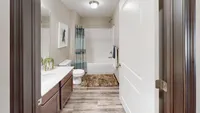 Bathrooms include bright lighting and large vanities.