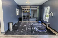 The fitness center is equipped for full-body workouts, including resistance bands, medicine balls, and kettlebells.
