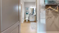 Everything in one place: This en suite bathroom features an oversized vanity, spacious shower/tub, and direct access to a walk-in closet.