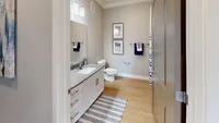 Start and end your day in a bathroom that’s as functional as it is stylish — with a wide vanity, sleek fixtures, and a full shower/tub combo.