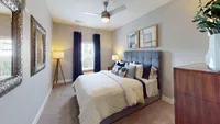 Spacious and serene, this primary bedroom features an en suite layout designed for both comfort and convenience.