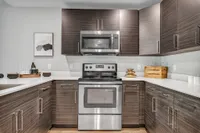 Cook and connectin our large kitchens featuring sleek stainless steel appliances and plenty of cabinets for storage.