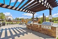 Outdoor gas grills are available to residents next to the outdoor lounge under the pergola.