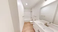 The Eleanor features a spacious bathroom with a large vanity, linien closet, and showe-bathtub.