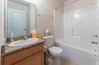 Modern Bathrooms with Granite Counterops and Tile Floors