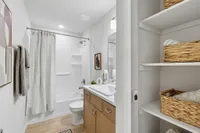 Guest bathroom with modern finishes and convenient built-in linen storage
