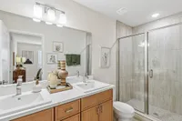 Spa-inspired primary bath featuring a spacious step-in tiled shower