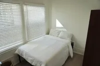 Spacious single bedroom featuring natural light
