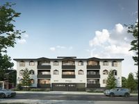 Contemporary apartment complex with modern black and white facade, featuring spacious balconies and surrounded by lush greenery and trees.
