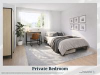 Bright and inviting private bedroom with a cozy bed, stylish desk, and a large window offering natural light.