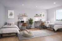 Contemporary double bedroom featuring twin beds with sleek workspace, cozy lighting, and a refreshing view.