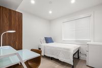 Fully furnished bedroom with a spacious layout, soft lighting, and a calm, inviting atmosphere.