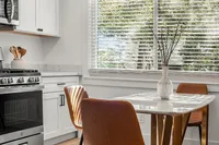 Kitchen and dining area with modern finishes, stainless steel appliances, and a seamless flow between cooking and dining spaces.
